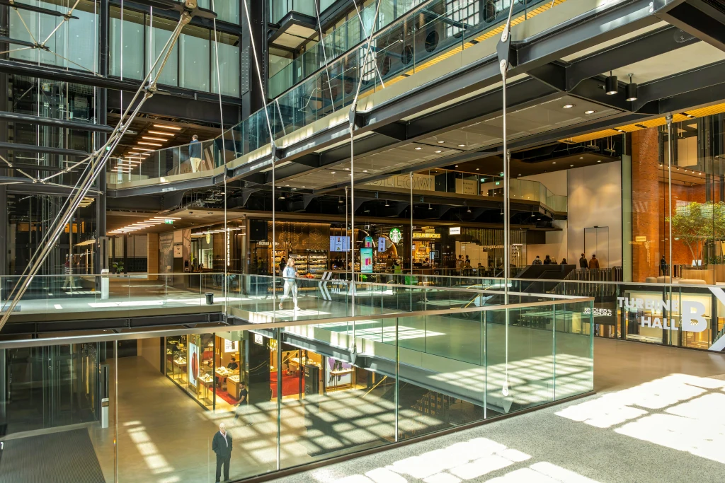 Hands shaking over a commercial lease contract representing data-driven lease acquisition services.